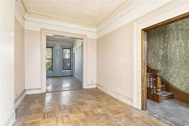 a view of a hallway with toilet and a window
