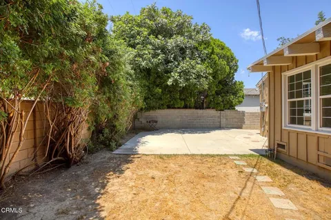 a view of a backyard of the house