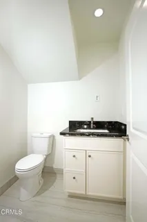 a white toilet sitting next to a white sink
