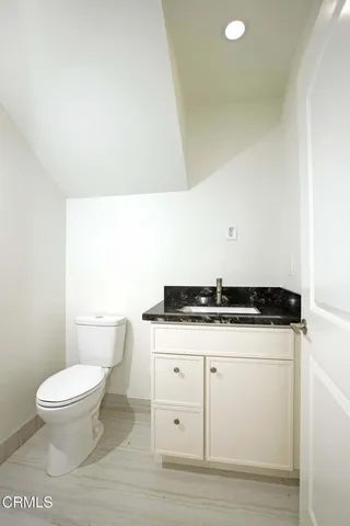 a white toilet sitting next to a white sink