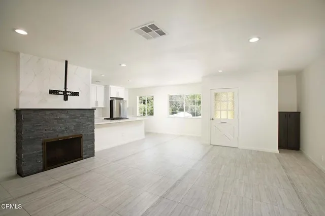 a view of a livingroom with an empty space and a fireplace