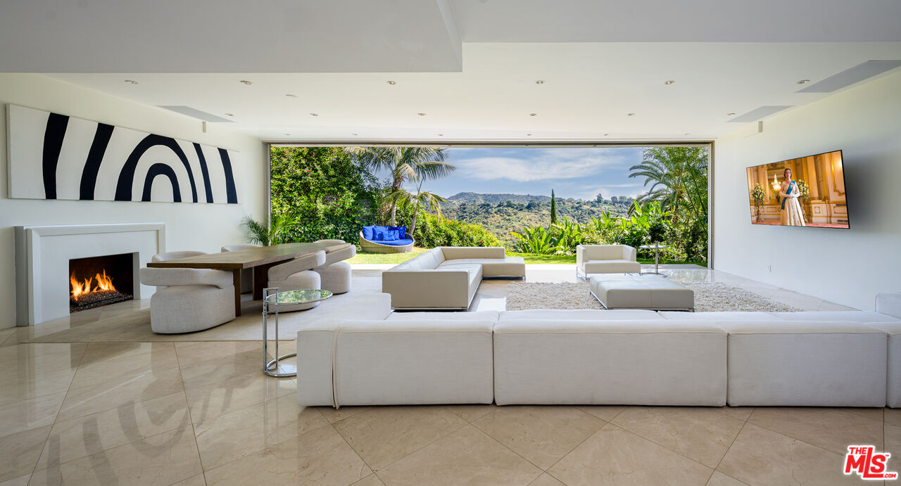 1466 Bel Air Road Los Angeles, CA 90077 - Photo 4 of 35 a living room with furniture and a fireplace