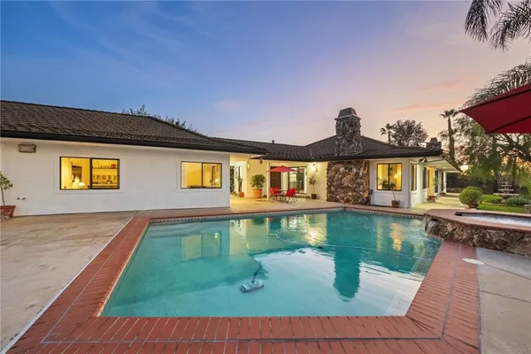 a front view of a house with swimming pool yard and outdoor seating