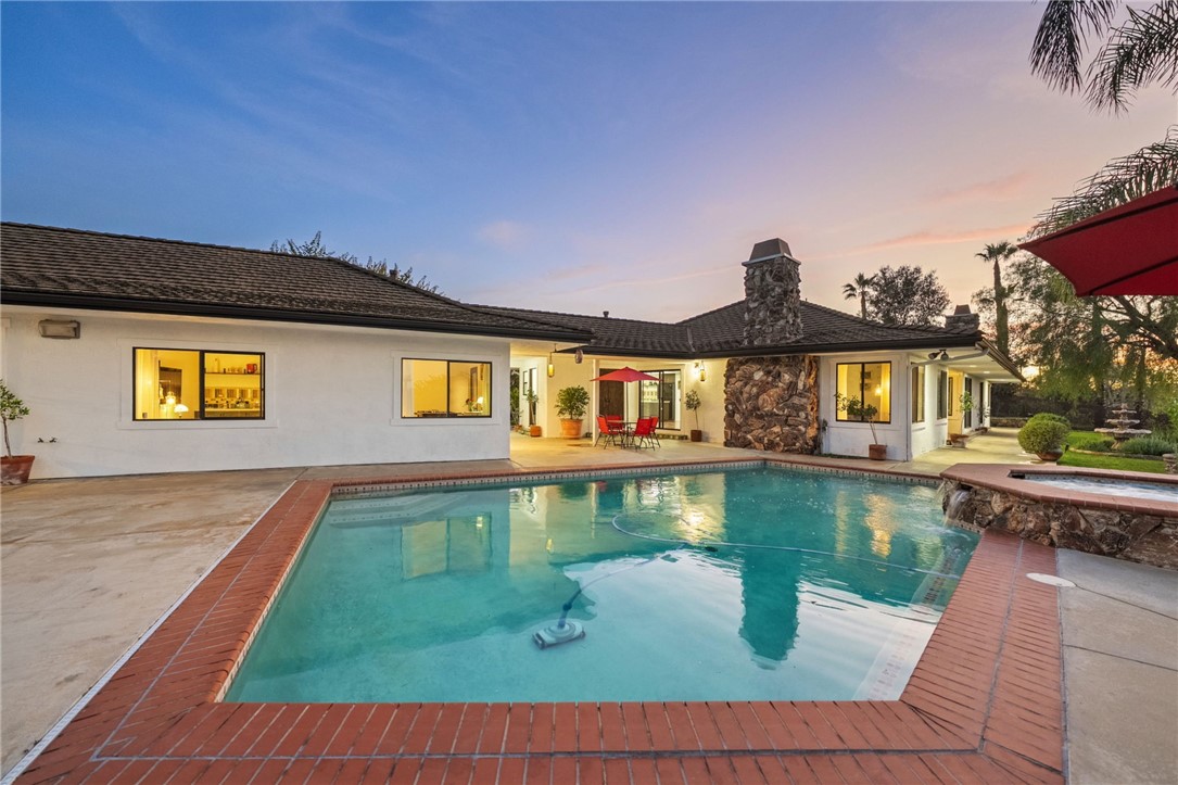 a front view of a house with swimming pool yard and outdoor seating