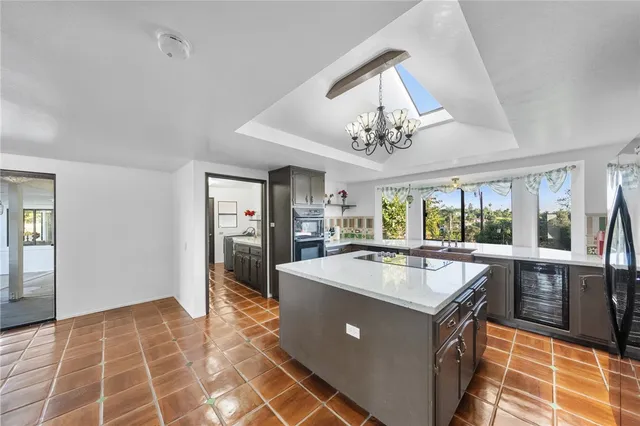 a kitchen with stainless steel appliances granite countertop a sink and a refrigerator