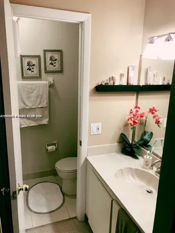 a bathroom with a toilet a sink and a mirror