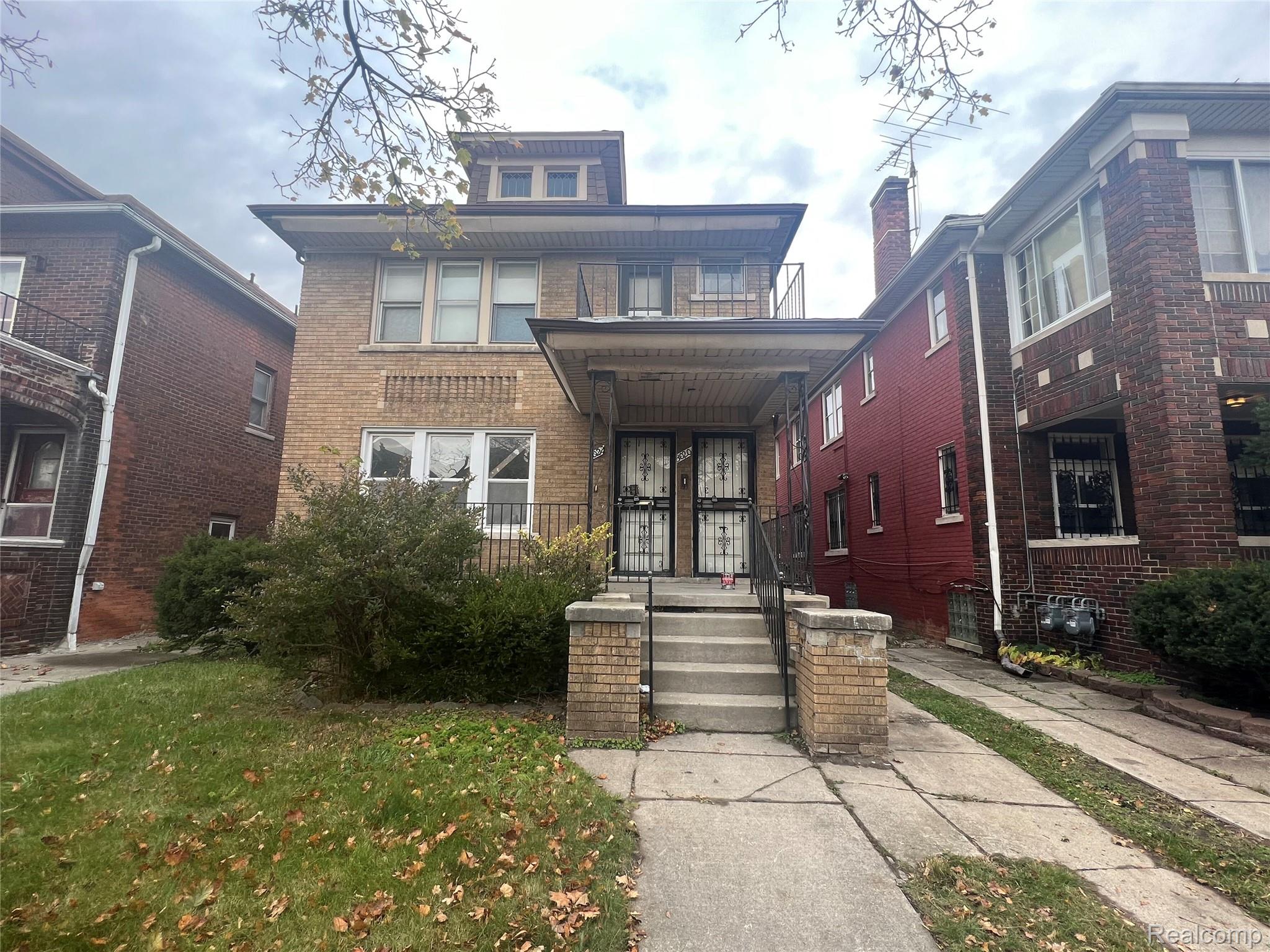 3020 Clements Street Detroit, MI 48238 - Photo 1 of 11 Brick facade with covered porch entry and upper-level balcony