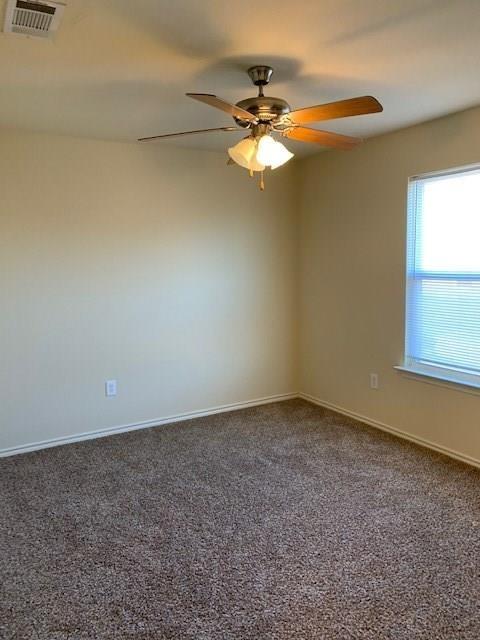 714 Parkplace Ridge Princeton, TX 75407 - Photo 7 of 15 Spacious room featuring neutral carpeting, light-toned wall paint, and a ceiling fan with integrated lighting