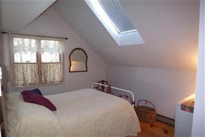 41 Pocha Road Edgartown, MA 02539 - Photo 8 of 10 a bedroom with a bed and a large window