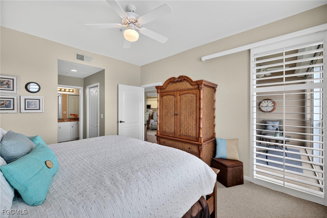 14081 Brant Point Circle, Unit 5403 Fort Myers, FL 33919 - Photo 14 of 41 a bedroom with a bed and a chandelier