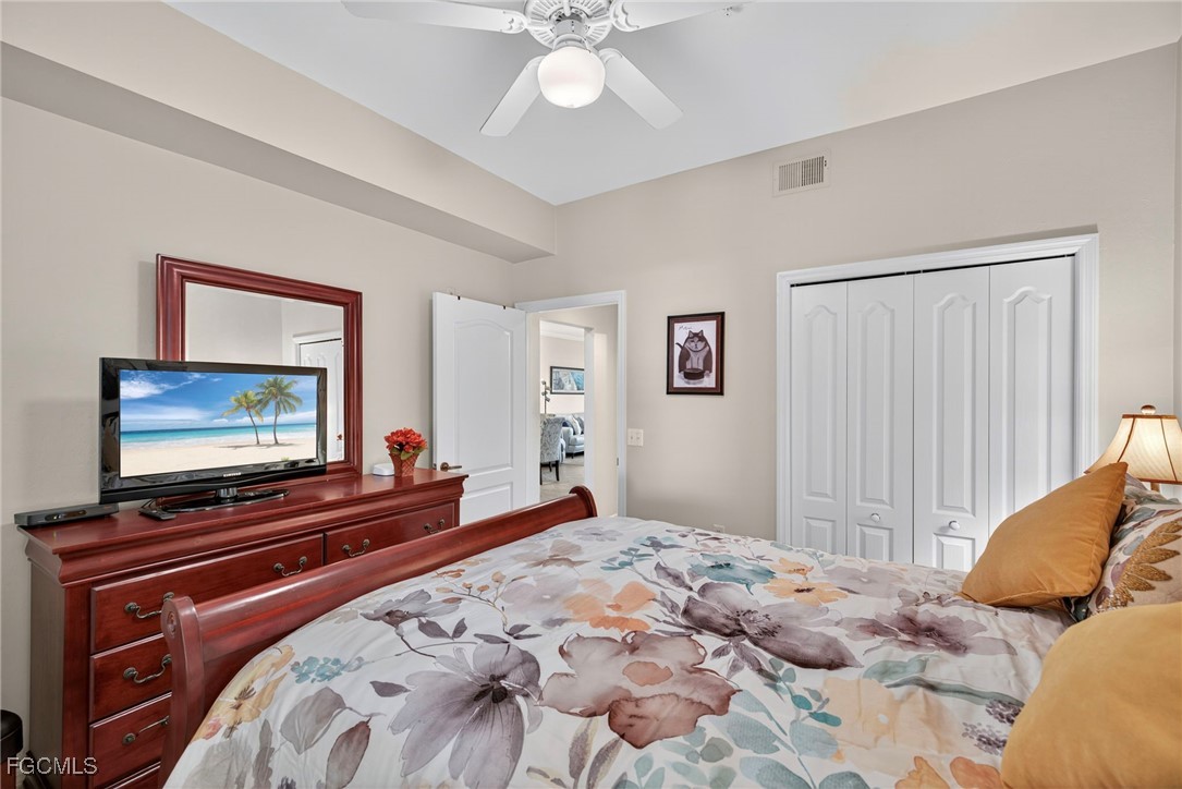 14081 Brant Point Circle, Unit 5403 Fort Myers, FL 33919 - Photo 18 of 41 a bedroom with a bed and a flat screen tv