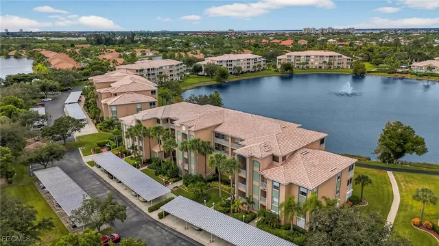 an aerial view of residential houses with outdoor space and lake view