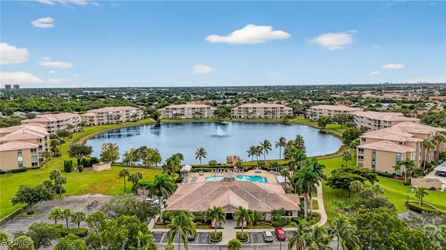 an aerial view of residential houses with outdoor space and lake view