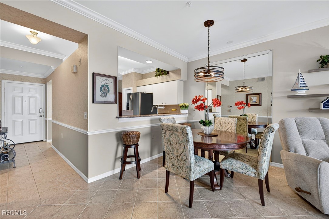 14081 Brant Point Circle, Unit 5403 Fort Myers, FL 33919 - Photo 7 of 41 a view of a dining room with furniture kitchen and chandelier