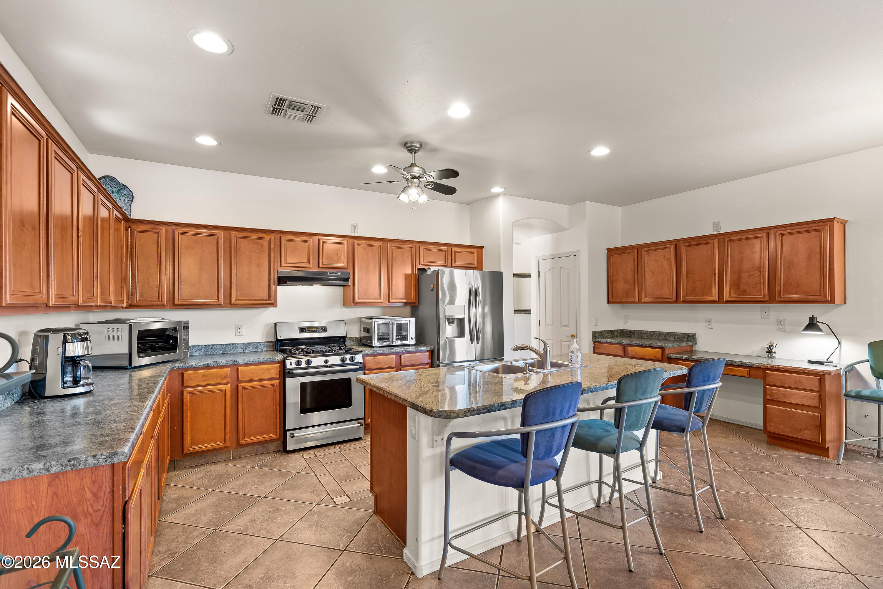 3396 North Camino Rio Colorado Tucson, AZ 85712 - Photo 7 of 32 a kitchen with lots of counter top space appliances and a center island
