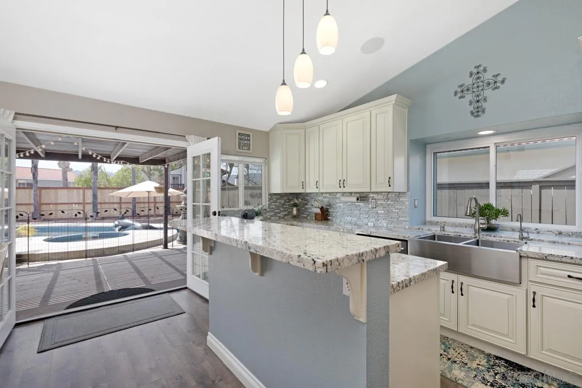 22895 Temet Street Wildomar, CA 92595 - Photo 12 of 36 a kitchen with a sink stove and refrigerator