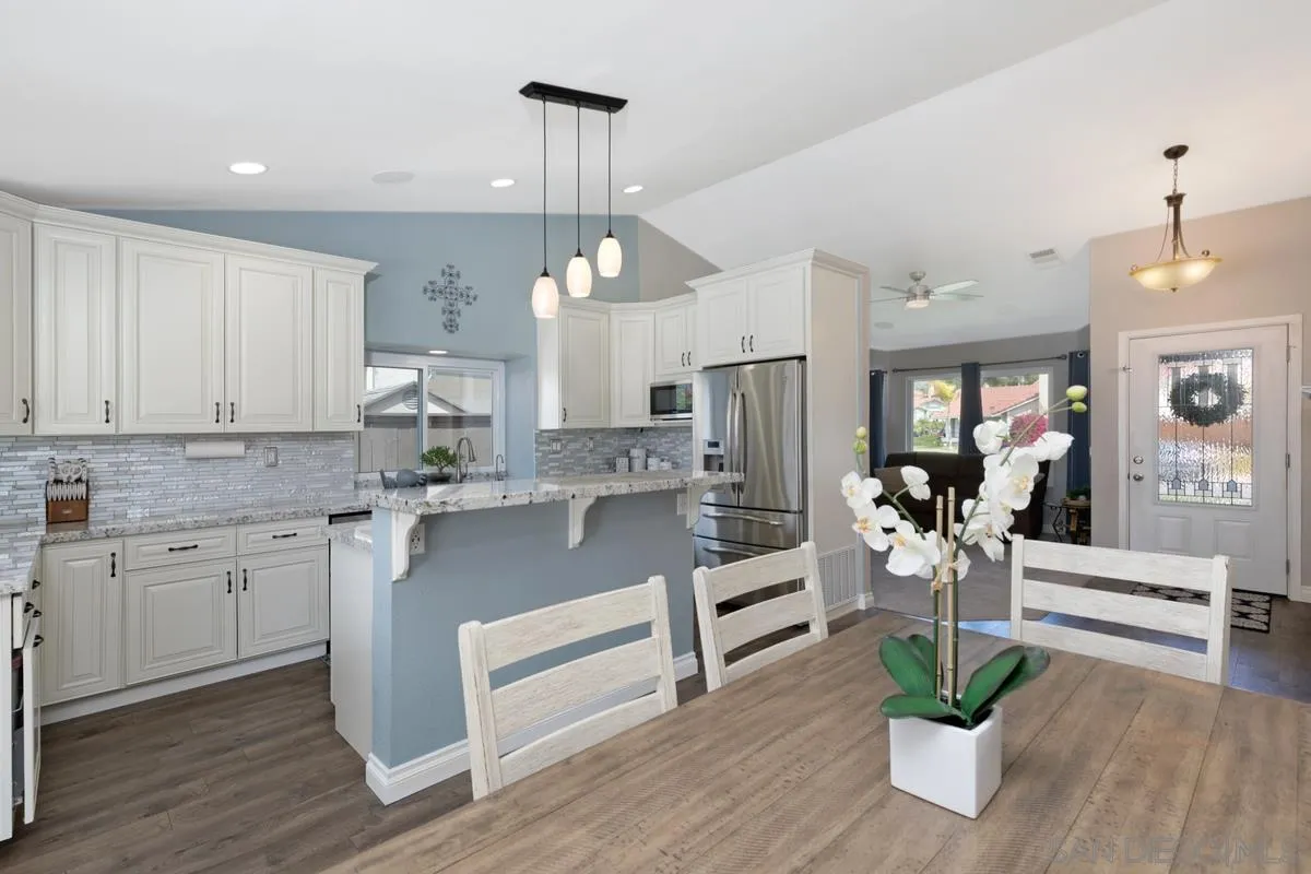 22895 Temet Street Wildomar, CA 92595 - Photo 13 of 36 a kitchen with sink cabinets and wooden floor