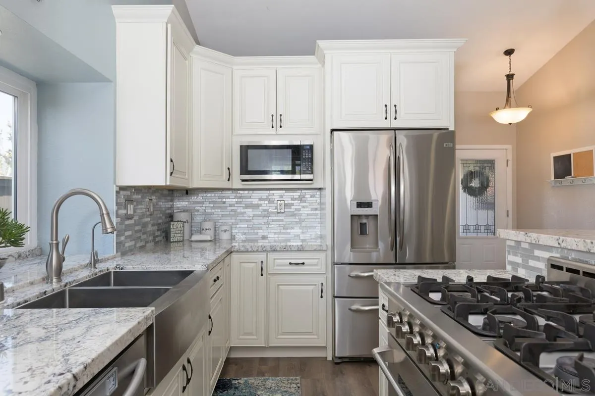22895 Temet Street Wildomar, CA 92595 - Photo 15 of 36 a kitchen with stainless steel appliances granite countertop a sink stove and refrigerator