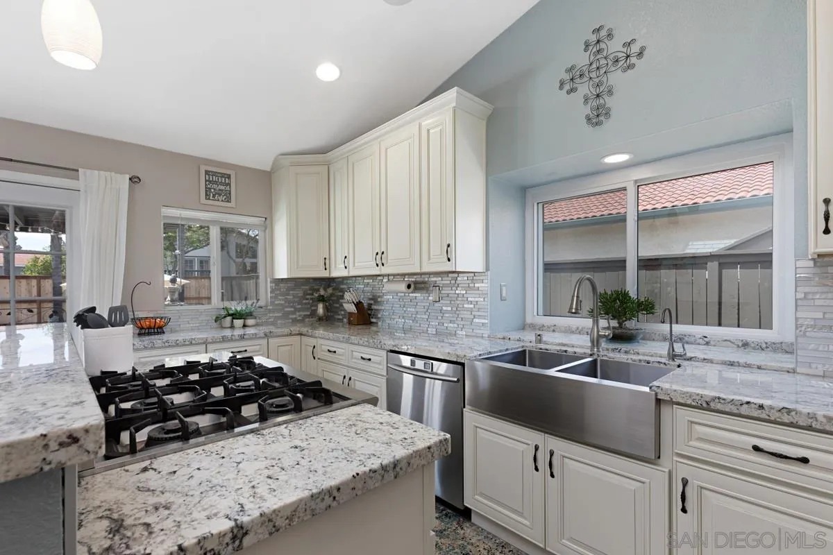 22895 Temet Street Wildomar, CA 92595 - Photo 16 of 36 a kitchen with stainless steel appliances a sink a stove and white cabinets