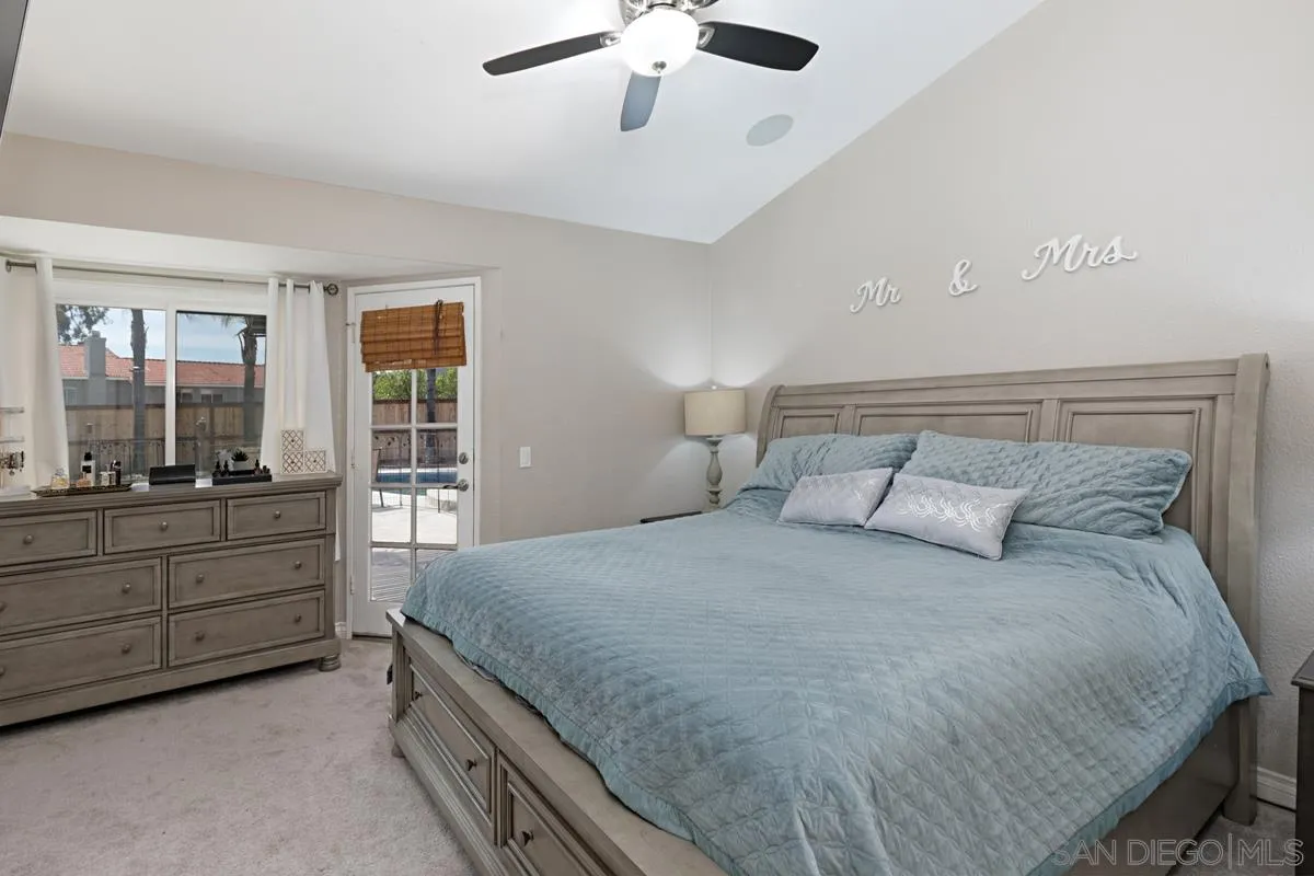 22895 Temet Street Wildomar, CA 92595 - Photo 18 of 36 a bedroom with a large bed and a window