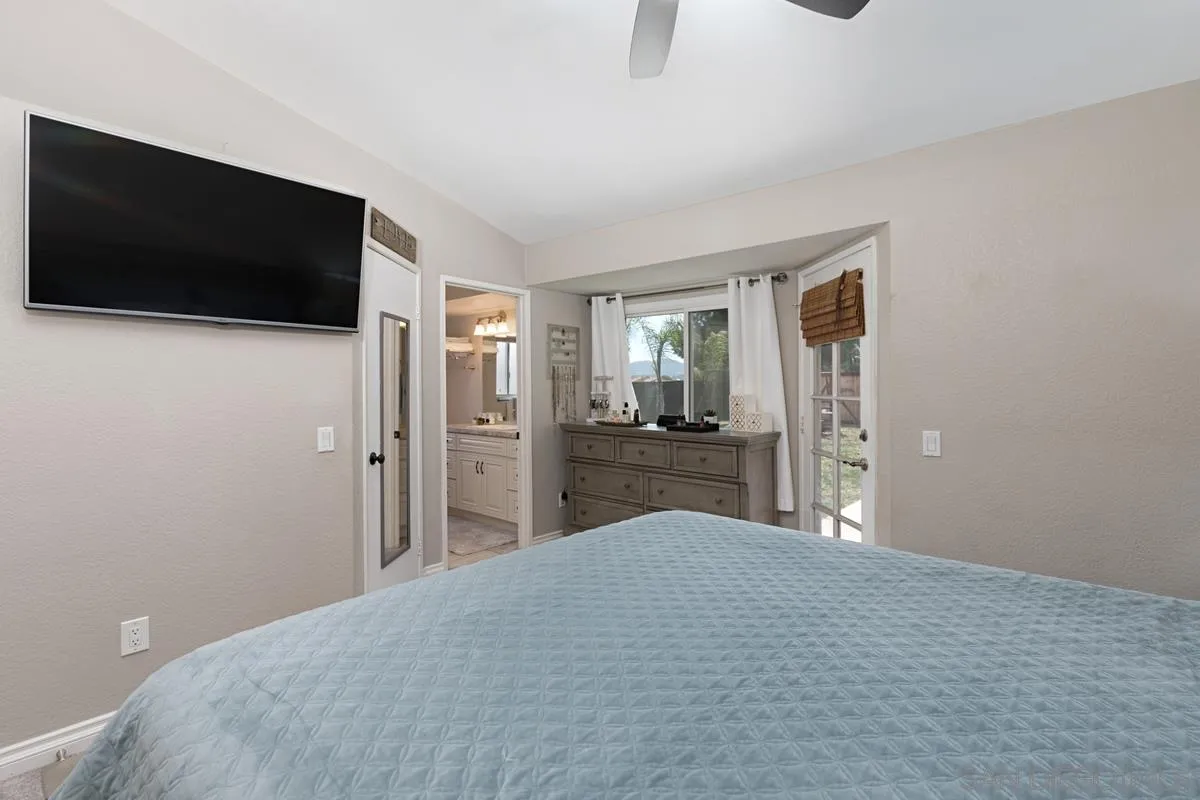 22895 Temet Street Wildomar, CA 92595 - Photo 20 of 36 a bedroom with a bed and a flat screen tv