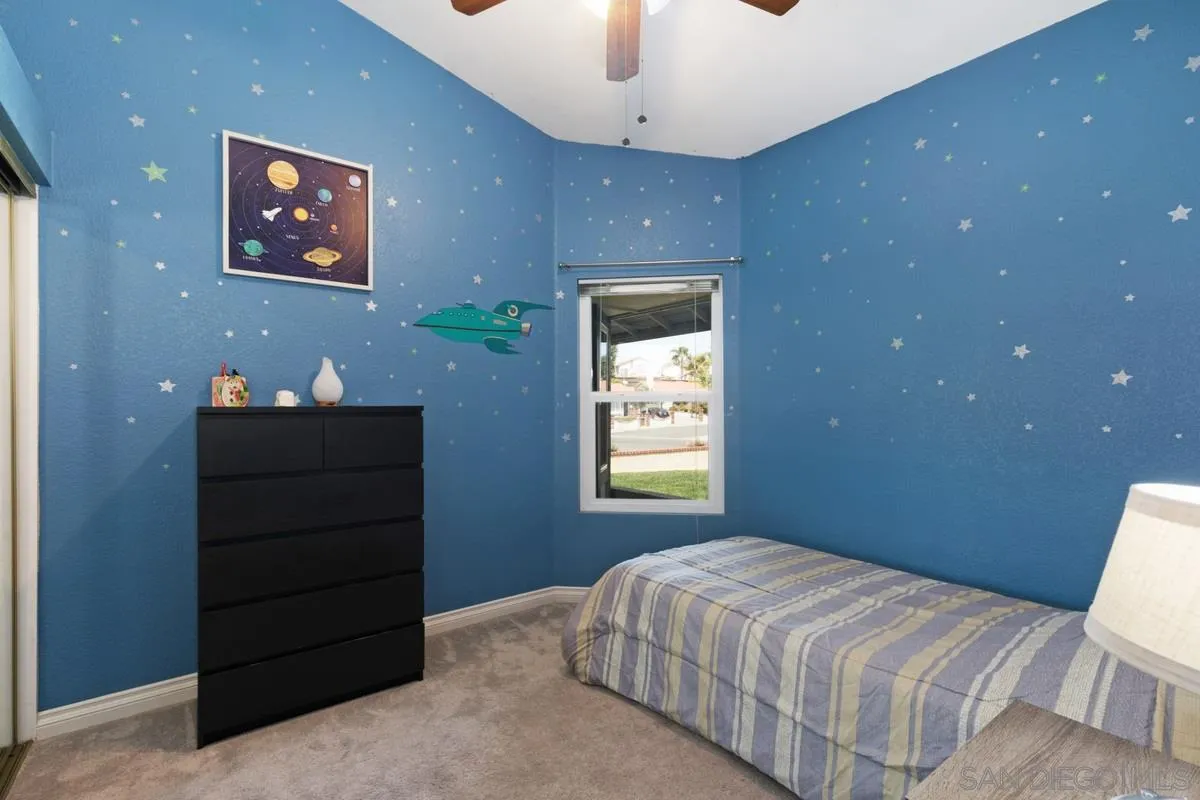 22895 Temet Street Wildomar, CA 92595 - Photo 23 of 36 a bedroom with a bed and a window