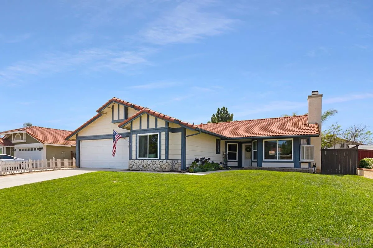 22895 Temet Street Wildomar, CA 92595 - Photo 4 of 36 a front view of a house with a garden