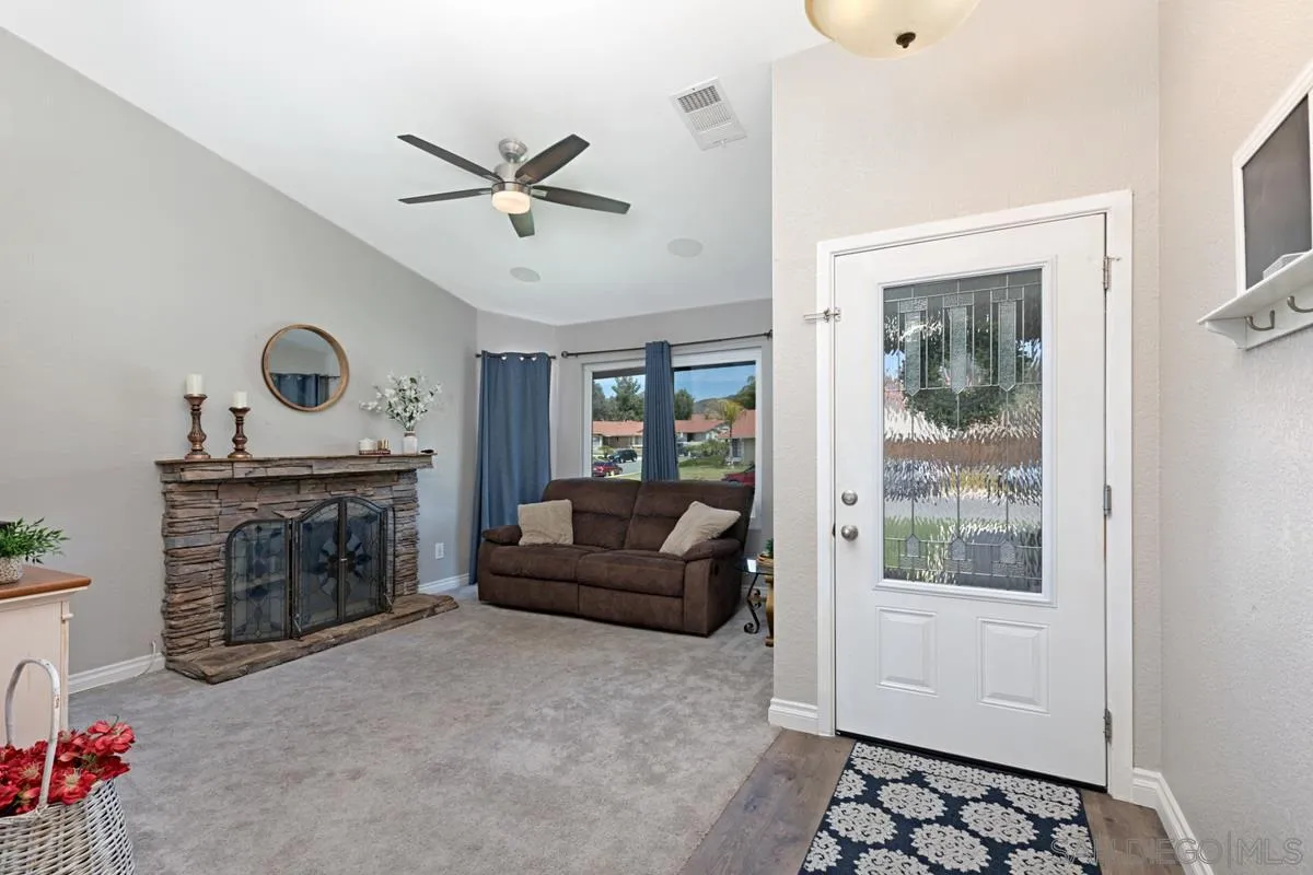 22895 Temet Street Wildomar, CA 92595 - Photo 6 of 36 a living room with furniture and a fireplace