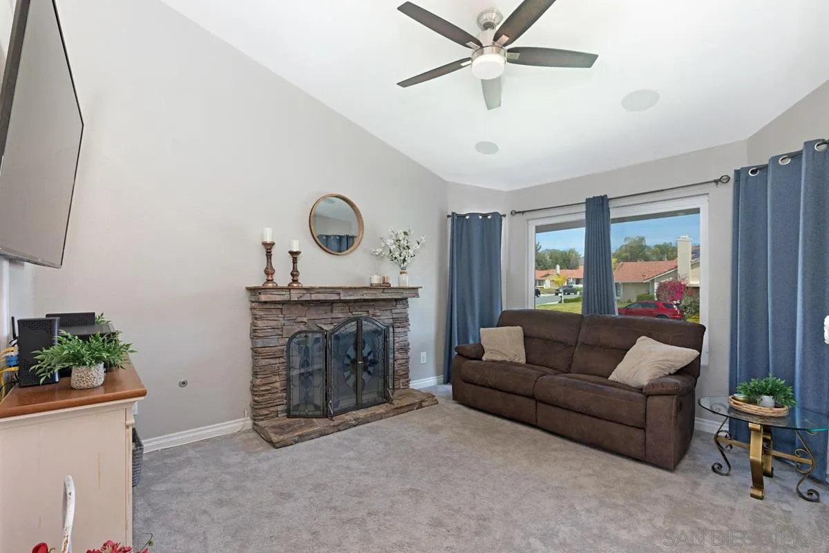 22895 Temet Street Wildomar, CA 92595 - Photo 7 of 36 a living room with furniture and a fireplace