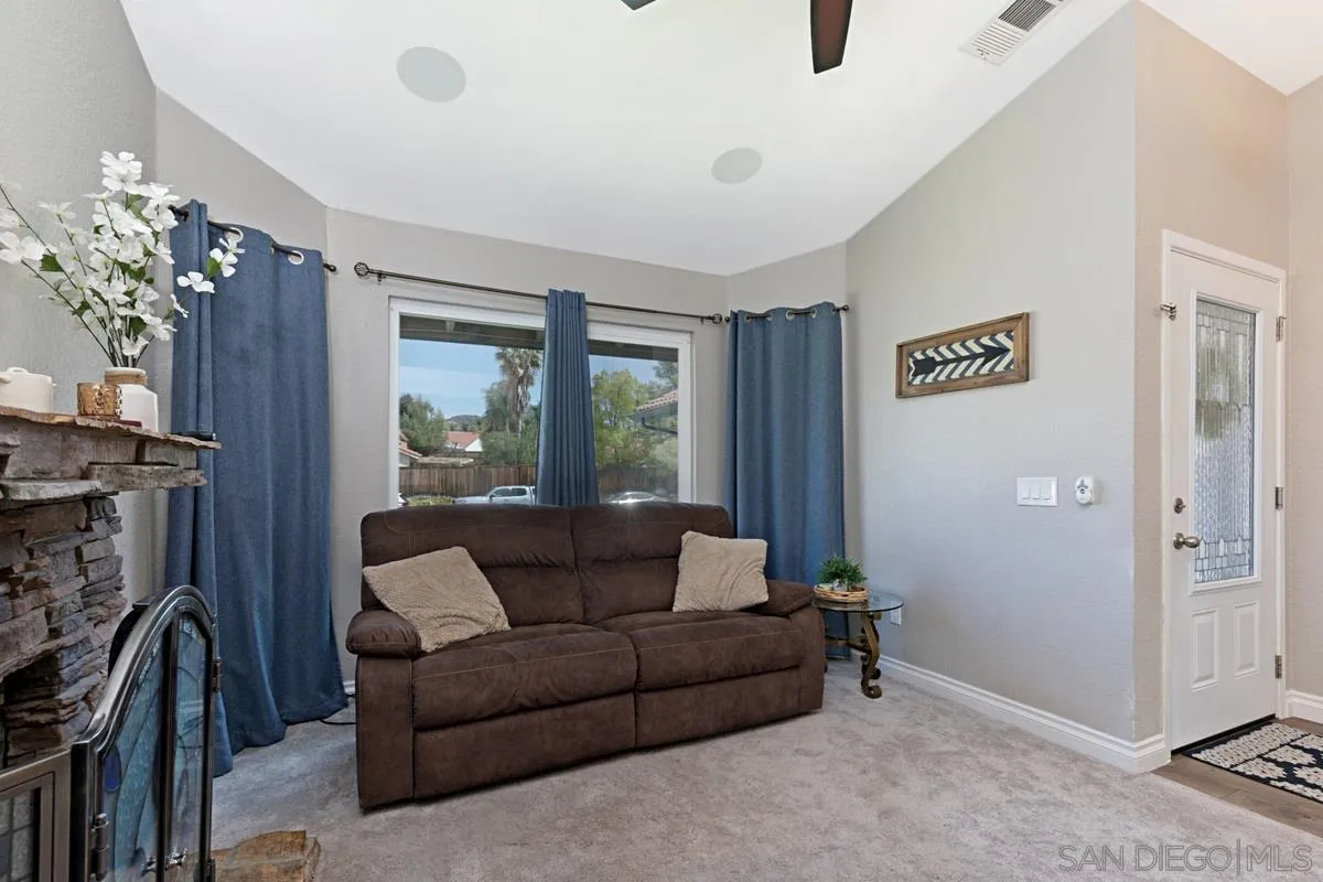 22895 Temet Street Wildomar, CA 92595 - Photo 8 of 36 a living room with furniture and a fireplace