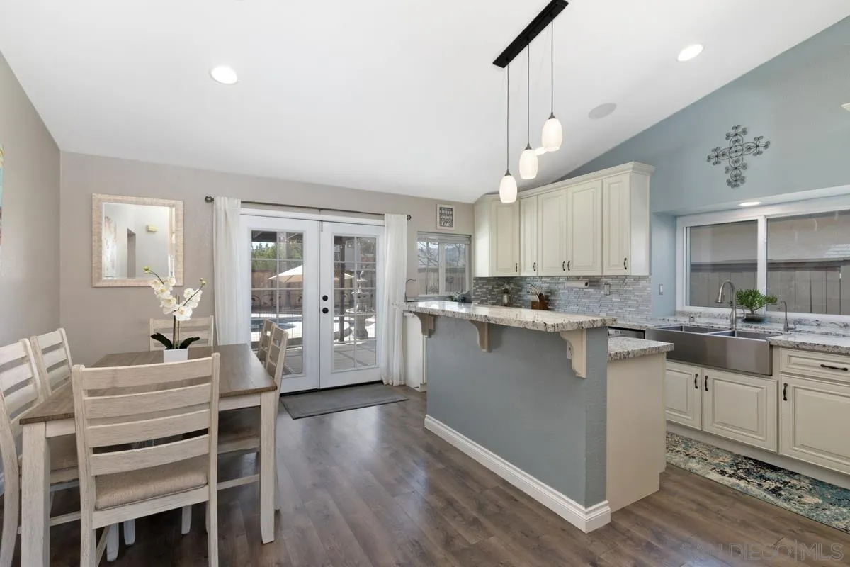 22895 Temet Street Wildomar, CA 92595 - Photo 10 of 36 a kitchen with a table chairs refrigerator and cabinets