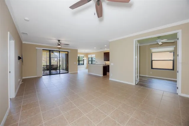 a dining room with furniture a chandelier and wooden floor