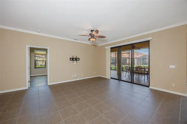 a living room with furniture and a floor to ceiling window