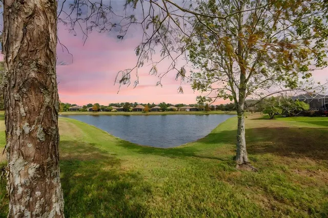 an aerial view of a house with garden space and lake view