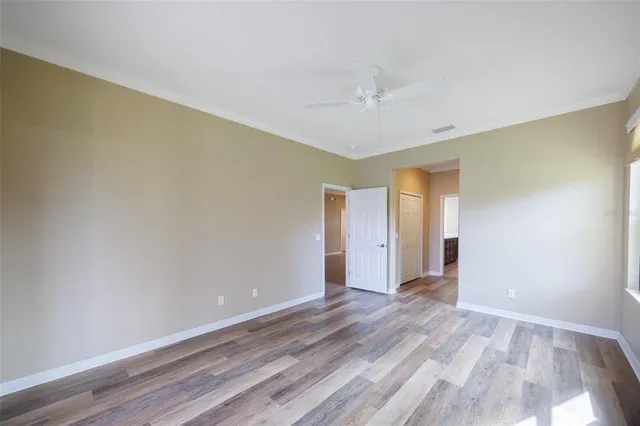 a sign board with a small yard and palm trees