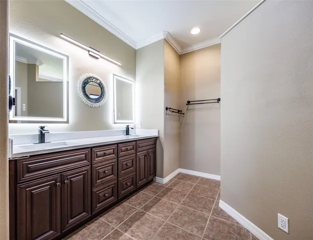 a view of a swimming pool with a patio and palm trees