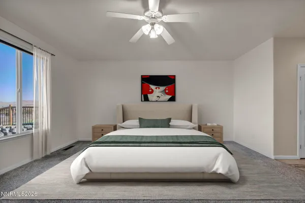 a bedroom with a large bed and a large window