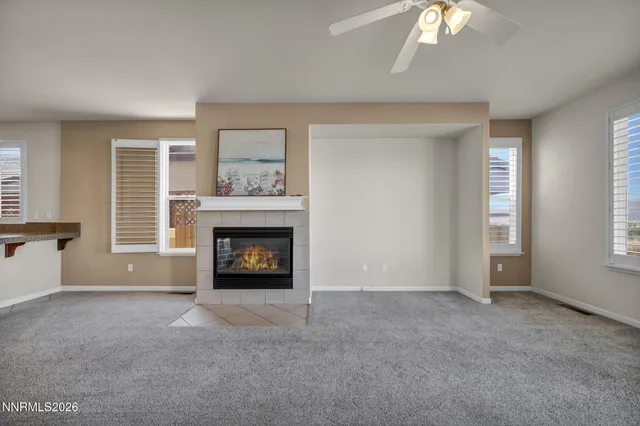 a view of a living room a dining room and kitchen with a large window