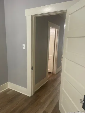 a view of a small space with wooden floor and closet