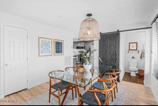 a view of a dining room with furniture and a chandelier
