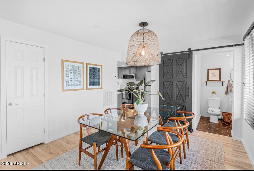 2929 North 39th Street, Unit 2 Phoenix, AZ 85018 - Photo 11 of 26 a view of a dining room with furniture and a chandelier