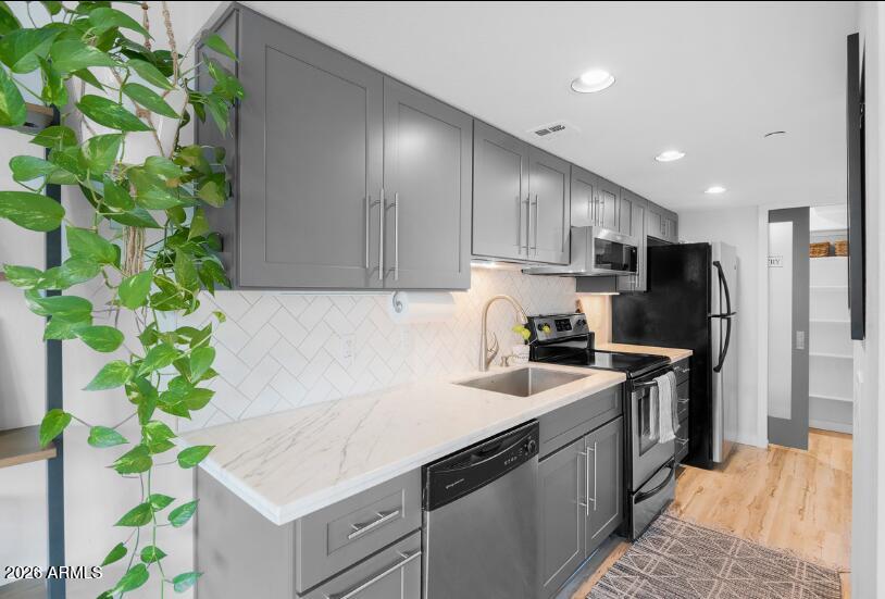 2929 North 39th Street, Unit 2 Phoenix, AZ 85018 - Photo 8 of 26 a kitchen with sink a refrigerator and a stove