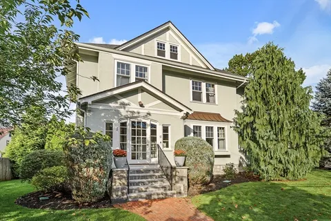 a front view of a house with a yard and porch
