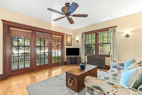a living room with furniture tv and a window