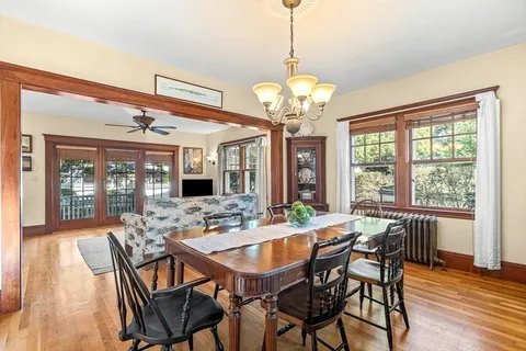 a view of a dining room with furniture wooden floor and chandelier