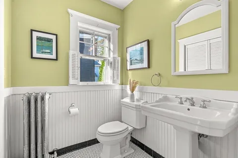 a bathroom with a sink mirror and toilet