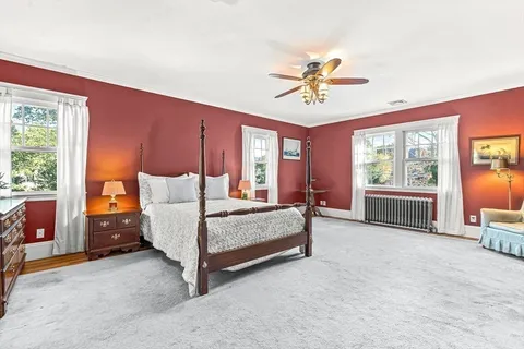 a bedroom with a bed and large window