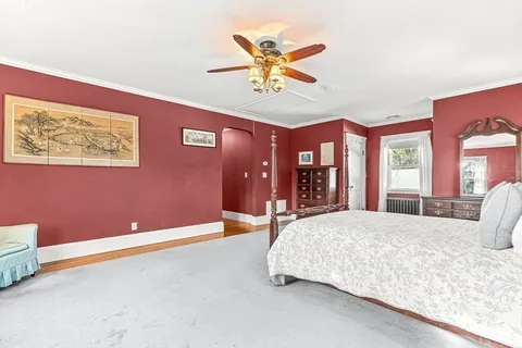 a bedroom with a bed and window