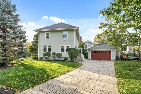 a view of a house with a yard and plants