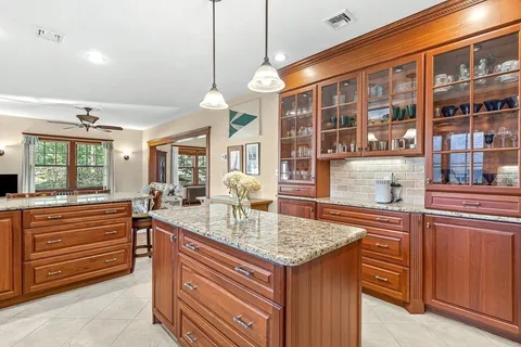 a kitchen with a stove and a wooden cabinets